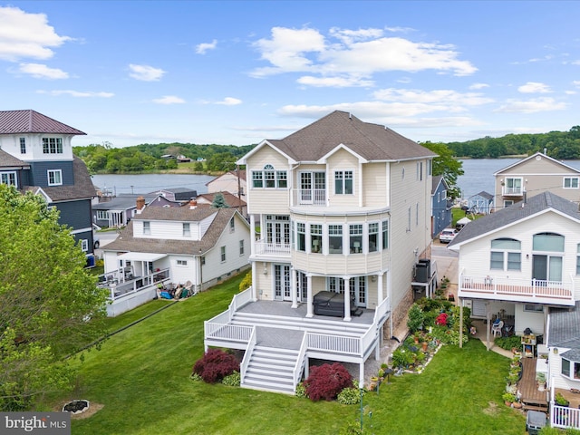 7839 Denton Ave, Baltimore, MD 21219 - back of property featuring a lawn, a deck with water view, and stairway
