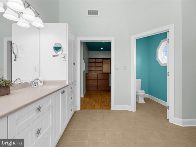 7839 Denton Ave, Baltimore, MD 21219 - bathroom featuring toilet, tile patterned floors, vanity, and baseboards
