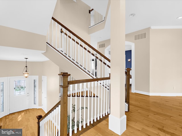 7839 Denton Ave, Baltimore, MD 21219 - stairway with hardwood / wood-style floors, a high ceiling, baseboards, and recessed lighting