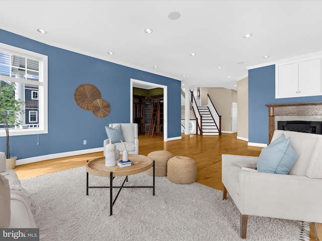 7839 Denton Ave, Baltimore, MD 21219 - living area with stairway, light wood-style floors, recessed lighting, baseboards, and a glass covered fireplace