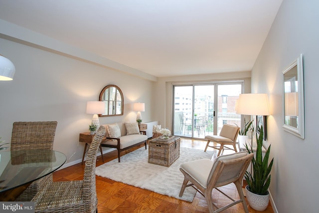 living area featuring baseboards