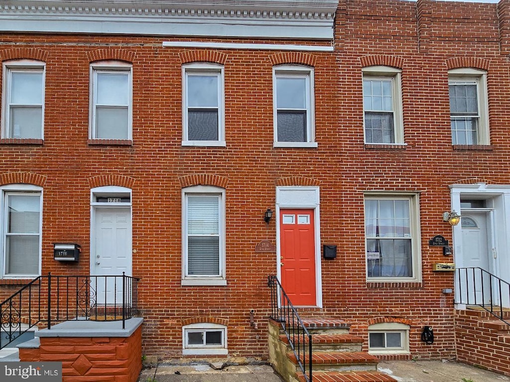 view of front of home featuring brick siding and entry steps