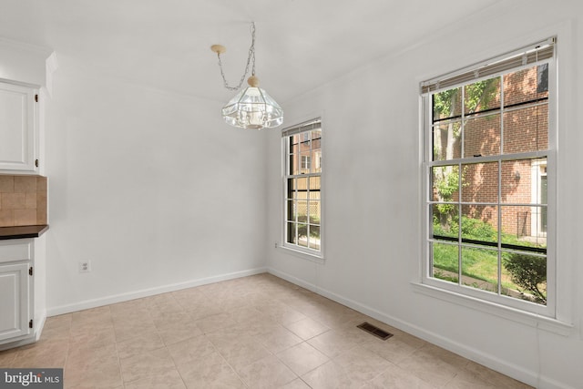 4849 Carriagepark Rd, Fairfax, VA 22032 - unfurnished dining area featuring a chandelier, ornamental molding, light tile patterned floors, and baseboards