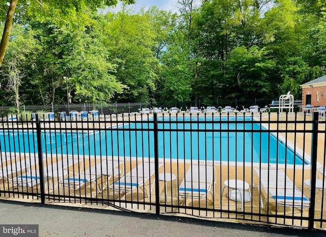 4849 Carriagepark Rd, Fairfax, VA 22032 - community pool featuring fence, a patio area, and view of wooded area
