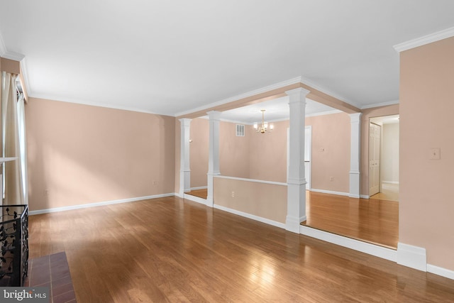 4849 Carriagepark Rd, Fairfax, VA 22032 - unfurnished living room featuring decorative columns, wood finished floors, baseboards, a chandelier, and crown molding