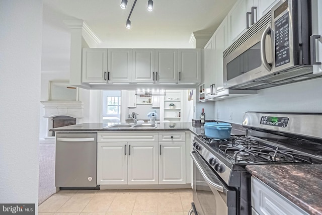 4415 Weatherington Ln Unit 401, Fairfax, VA 22030 - kitchen featuring stainless steel appliances, a sink, a peninsula, light tile patterned floors, and white cabinets