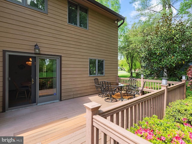 wooden terrace featuring outdoor dining area