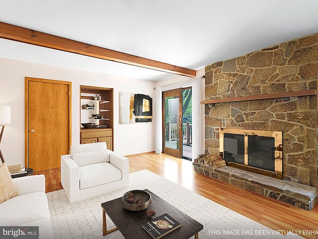 living room with beam ceiling and wood finished floors