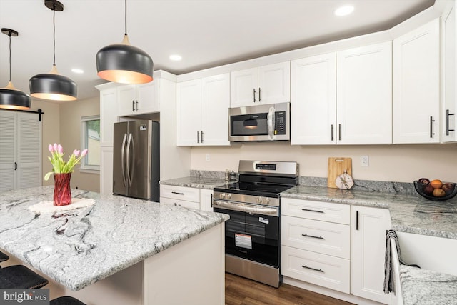 203 Coville Dr, Browns Mills, NJ 08015 - kitchen with appliances with stainless steel finishes, recessed lighting, a breakfast bar area, white cabinets, and hanging light fixtures