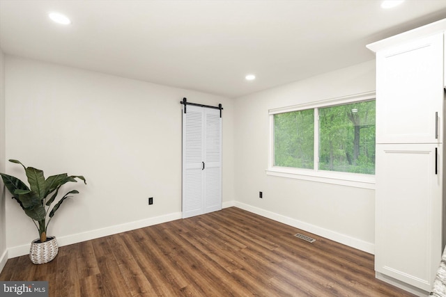 203 Coville Dr, Browns Mills, NJ 08015 - empty room featuring a barn door, wood finished floors, recessed lighting, and baseboards