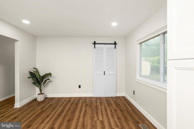 203 Coville Dr, Browns Mills, NJ 08015 - spare room featuring a barn door, wood finished floors, baseboards, and recessed lighting