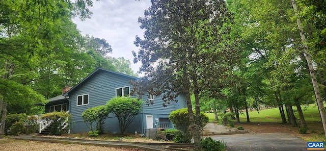 7 Spoon Ter, Palmyra, VA 22963 - view of home's exterior featuring a chimney, driveway, and stairway
