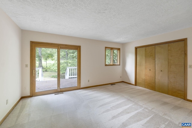 7 Spoon Ter, Palmyra, VA 22963 - unfurnished bedroom featuring access to exterior, carpet flooring, baseboards, and a textured ceiling