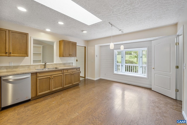 7 Spoon Ter, Palmyra, VA 22963 - kitchen with dishwasher, a skylight, a textured ceiling, brown cabinets, and a sink