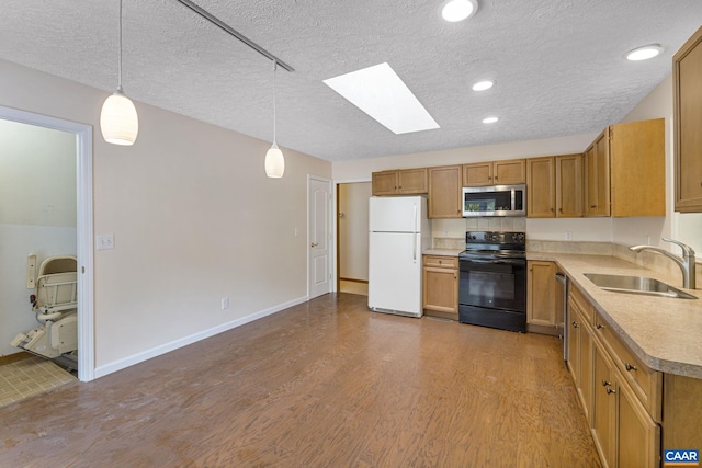 7 Spoon Ter, Palmyra, VA 22963 - kitchen with stainless steel appliances, a sink, a skylight, light countertops, and wood finished floors