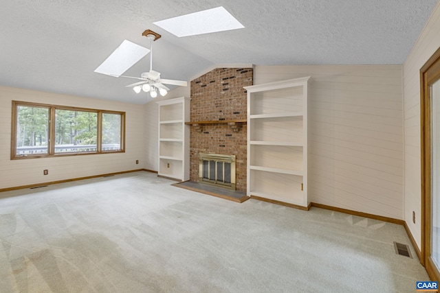 7 Spoon Ter, Palmyra, VA 22963 - unfurnished living room featuring a skylight, lofted ceiling, a textured ceiling, baseboards, and carpet floors