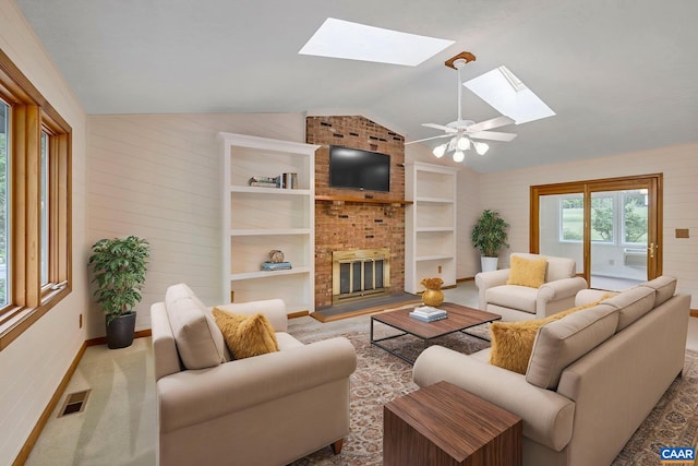 7 Spoon Ter, Palmyra, VA 22963 - living area with a skylight, lofted ceiling, a brick fireplace, baseboards, and built in shelves