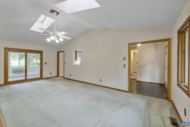 7 Spoon Ter, Palmyra, VA 22963 - carpeted spare room featuring a skylight, vaulted ceiling, baseboards, and wood walls
