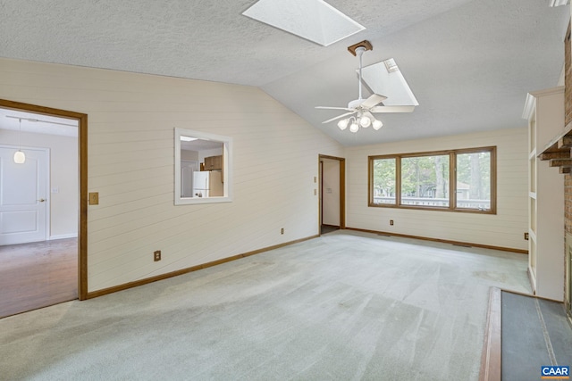 7 Spoon Ter, Palmyra, VA 22963 - unfurnished living room with a skylight, lofted ceiling, a ceiling fan, light carpet, and baseboards