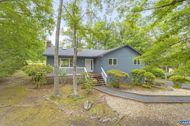7 Spoon Ter, Palmyra, VA 22963 - single story home featuring a chimney, roof with shingles, and a wooden deck