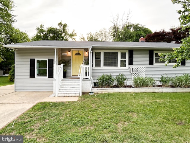 single story home with a front yard and a chimney
