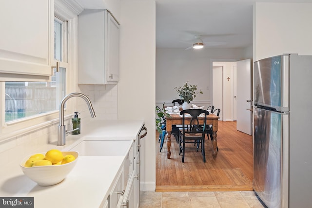 1808 Bay Ridge Ave, Annapolis, MD 21403 - kitchen featuring stainless steel appliances, a sink, decorative backsplash, light countertops, and white cabinetry