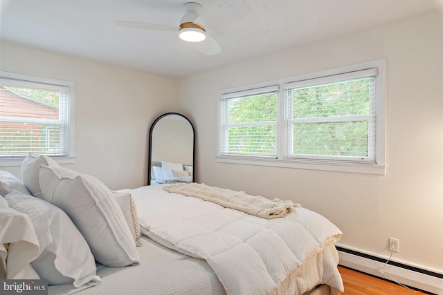 1808 Bay Ridge Ave, Annapolis, MD 21403 - bedroom with a baseboard heating unit, wood finished floors, and a ceiling fan