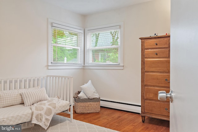 1808 Bay Ridge Ave, Annapolis, MD 21403 - bedroom featuring a baseboard heating unit and wood finished floors