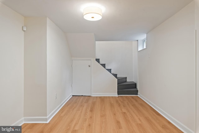 1808 Bay Ridge Ave, Annapolis, MD 21403 - basement featuring light wood finished floors, baseboards, and stairway