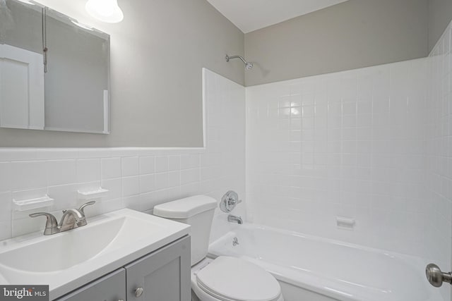 3311 Meridian St, Philadelphia, PA 19136 - bathroom featuring toilet, tub / shower combination, vanity, and tile walls