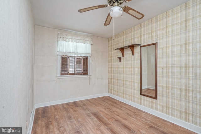 3311 Meridian St, Philadelphia, PA 19136 - unfurnished room with wood finished floors, ceiling fan, wallpapered walls, and baseboards