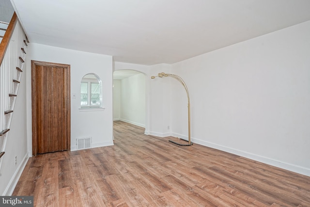 3311 Meridian St, Philadelphia, PA 19136 - empty room with wood finished floors, arched walkways, and baseboards