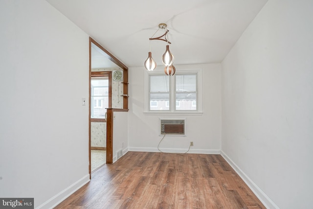 3311 Meridian St, Philadelphia, PA 19136 - unfurnished dining area with a wall unit AC, wood finished floors, and baseboards