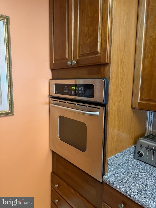 1250 S Washington St S Unit 207, Alexandria, VA 22314 - kitchen featuring oven and brown cabinets