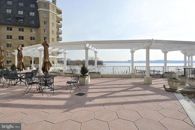 1250 S Washington St S Unit 207, Alexandria, VA 22314 - view of patio with a pergola, a water view, and fence
