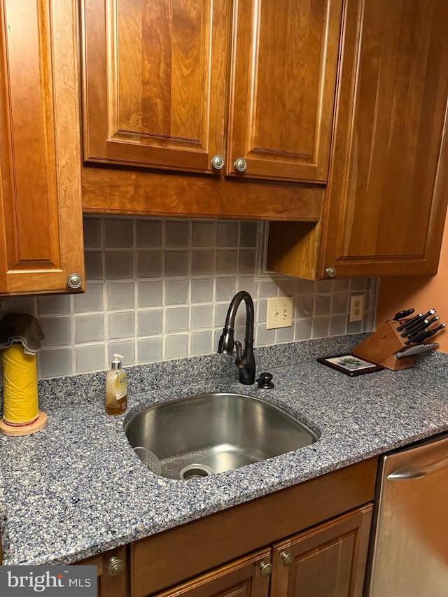 1250 S Washington St S Unit 207, Alexandria, VA 22314 - kitchen with a sink, backsplash, dark stone counters, brown cabinets, and dishwasher