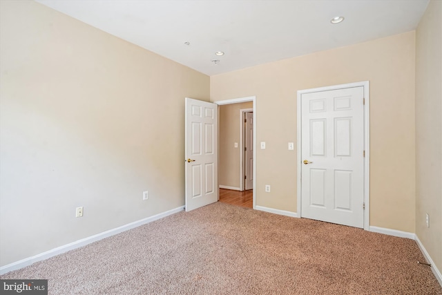 unfurnished bedroom featuring carpet, baseboards, and recessed lighting