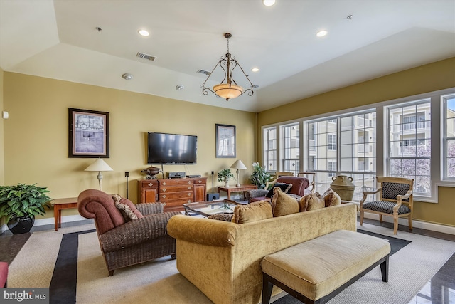 living area featuring healthy amount of natural light, baseboards, and recessed lighting