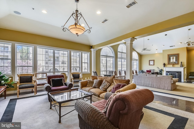 living room featuring decorative columns, lofted ceiling, ceiling fan, recessed lighting, and a fireplace