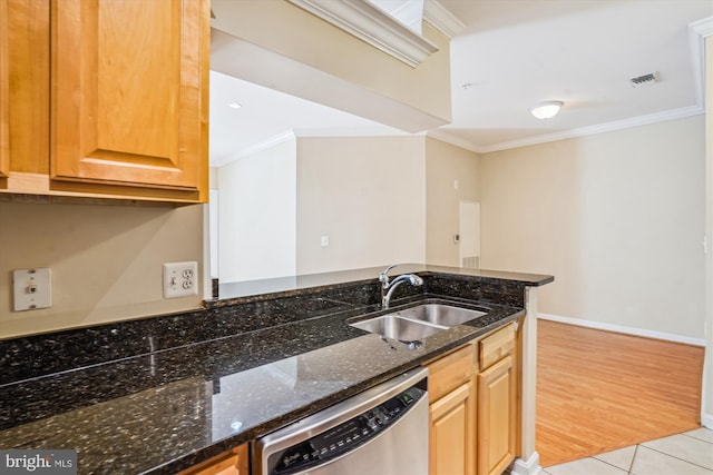 kitchen featuring dishwasher, a sink, ornamental molding, dark stone countertops, and baseboards
