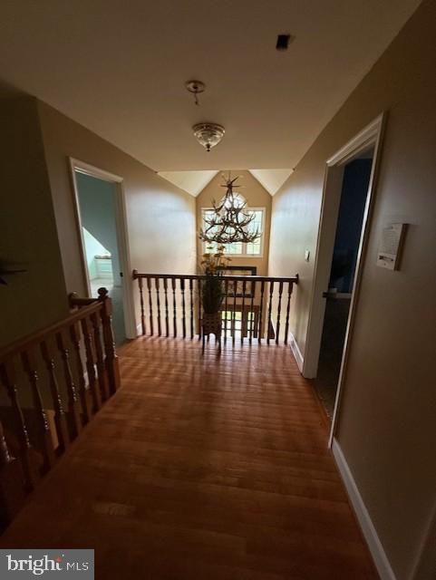 15920 River Bend Ct, Williamsport, MD 21795 - hall with an upstairs landing, wood finished floors, a chandelier, vaulted ceiling, and baseboards