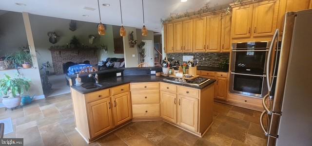 15920 River Bend Ct, Williamsport, MD 21795 - kitchen featuring appliances with stainless steel finishes, a sink, dark countertops, tasteful backsplash, and open floor plan
