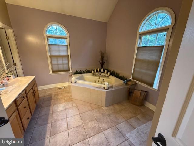 15920 River Bend Ct, Williamsport, MD 21795 - bathroom with plenty of natural light, vaulted ceiling, a bath, and baseboards