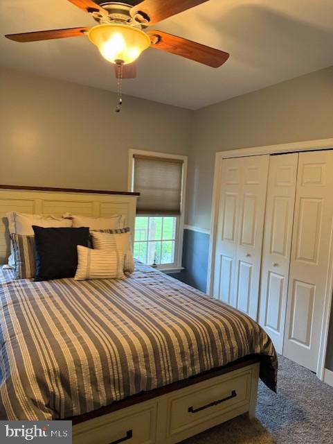 15920 River Bend Ct, Williamsport, MD 21795 - bedroom featuring dark carpet, a closet, and a ceiling fan