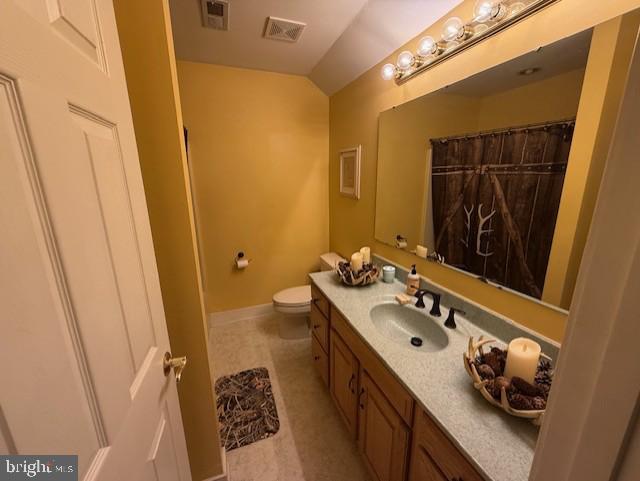 15920 River Bend Ct, Williamsport, MD 21795 - full bathroom featuring vanity, toilet, baseboards, and vaulted ceiling