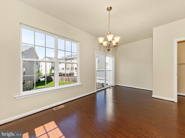 6207 Margarita Way, Frederick, MD 21703 - spare room featuring a chandelier, wood-type flooring, and baseboards