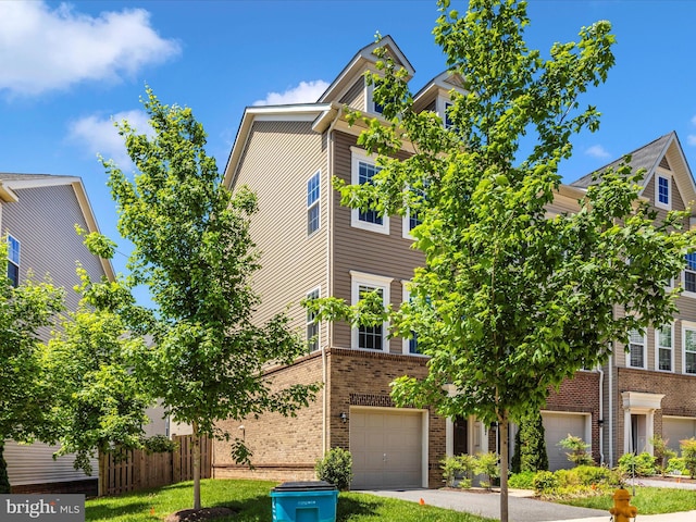 6207 Margarita Way, Frederick, MD 21703 - townhome / multi-family property with brick siding, an attached garage, and driveway