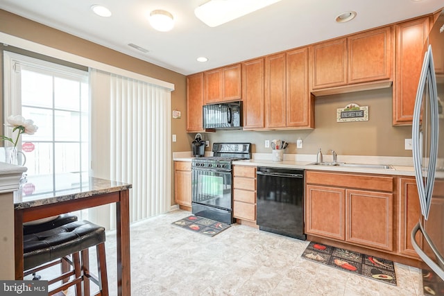 2501 Lexington Mews, Woolwich Twp, NJ 08085 - kitchen with black appliances, a sink, recessed lighting, and brown cabinets