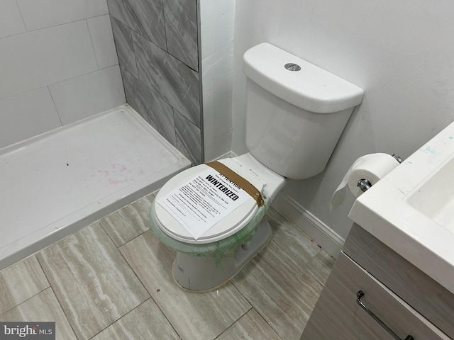 full bathroom with toilet, a shower stall, and vanity