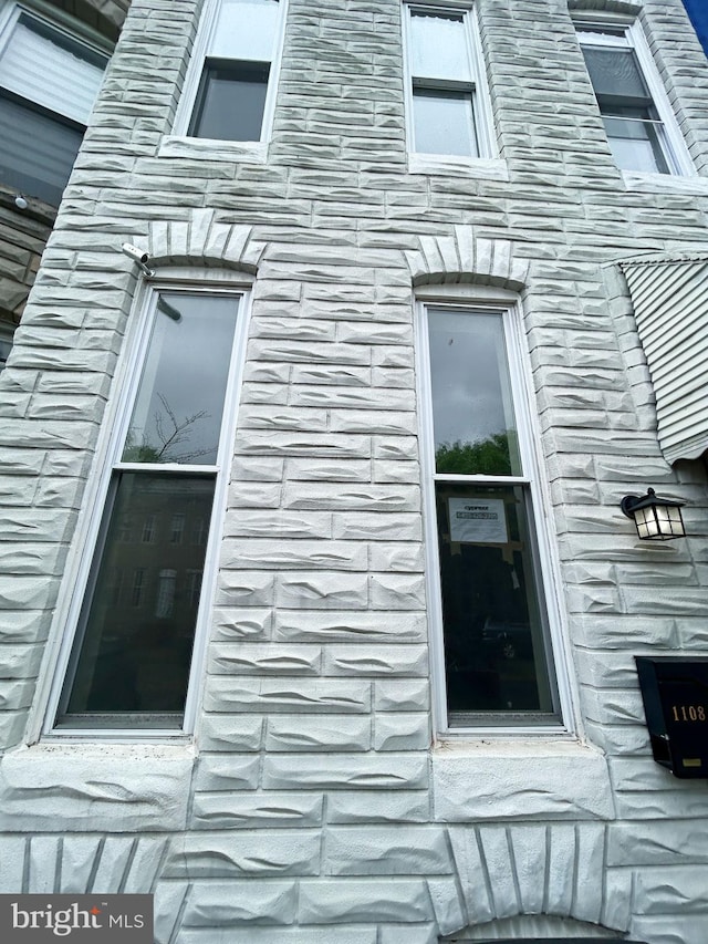 view of side of property with stone siding